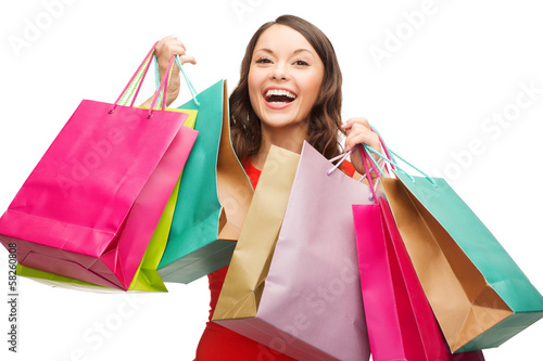 Photo: woman in red dress with colorful shopping bags woman in red dress with colorful shopping bags
