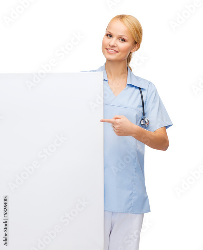 Photo: smiling female doctor or nurse with blank board smiling female doctor or nurse with blank board