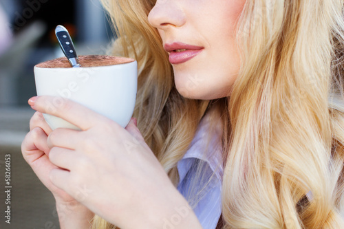 Photo: Portrait of beautiful woman drinking coffee Portrait of beautiful woman drinking coffee