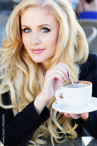 Photo: Portrait of beautiful woman drinking coffee Portrait of beautiful woman drinking coffee