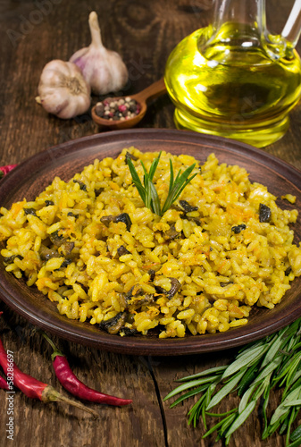 Photo: mushroom risotto with herbs in a clay plate mushroom risotto with herbs in a clay plate