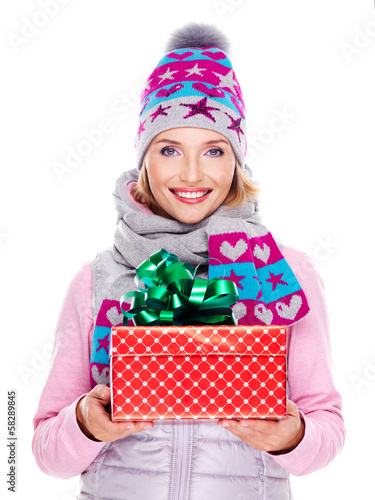 Photo: happy smiling woman giving a christmas gift happy smiling woman giving a christmas gift