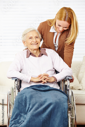 Photo: Seniorin im Rollstuhl wird von Tochter betreut Seniorin im Rollstuhl wird von Tochter betreut
