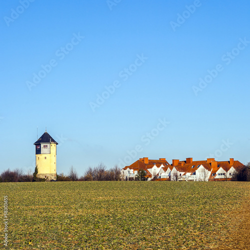 Photo: old Water tower in beautiful landscape with blue sky old Water tower in beautiful landscape with blue sky