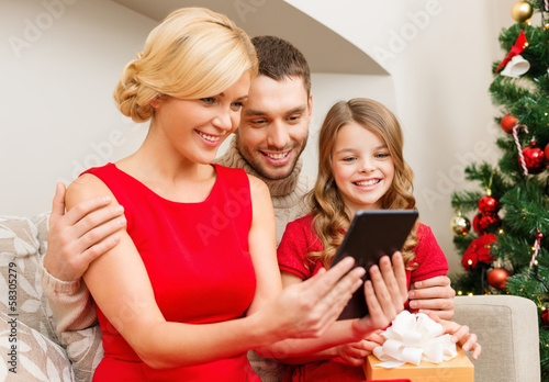 Photo: smiling family with tablet pc smiling family with tablet pc