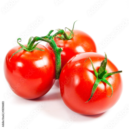 Photo: Closeup of tomatoes on the vine isolated on white Closeup of tomatoes on the vine isolated on white