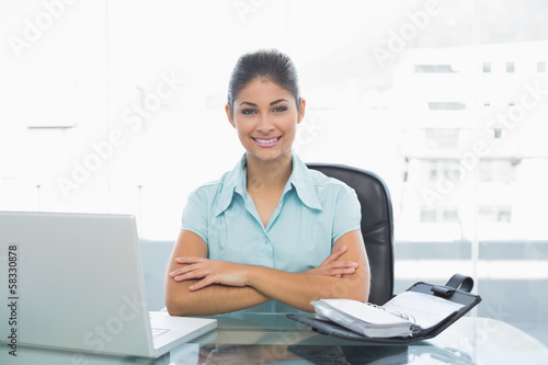 Photo: Elegant businesswoman with laptop in office Elegant businesswoman with laptop in office