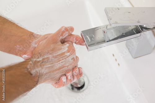Photo: Washing hands with soap under running water Washing hands with soap under running water