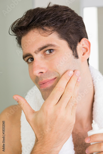 Photo: Man applying moisturizer on face Man applying moisturizer on face