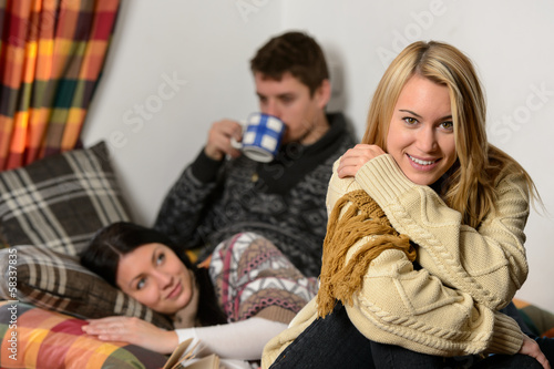 Photo: Young friends spend winter holiday cozy cottage Young friends spend winter holiday cozy cottage