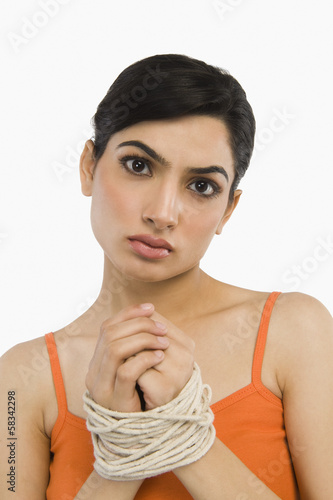 Photo: Woman's hands tied with a rope Woman's hands tied with a rope