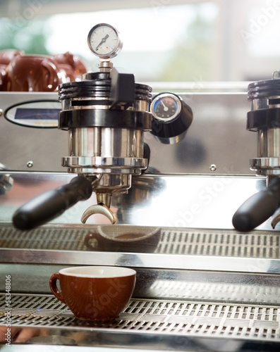 Photo: Cup Under Portafilter Attached To Coffee Machine Cup Under Portafilter Attached To Coffee Machine