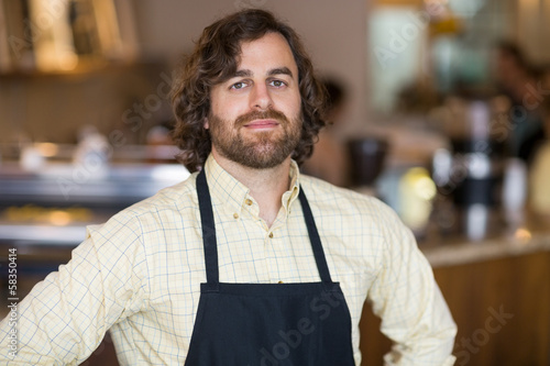 Photo: Confident Owner Standing In Espresso Bar Confident Owner Standing In Espresso Bar