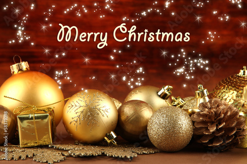 Photo: Beautiful Christmas decorations on table on wooden background Beautiful Christmas decorations on table on wooden background