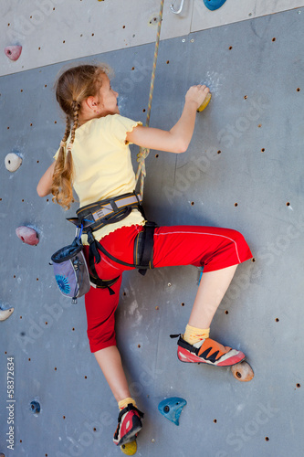 Photo: teenager climbing a rock wall teenager climbing a rock wall