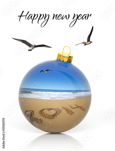 Photo: Christmas ball with 2014 written on sandy beach Christmas ball with 2014 written on sandy beach