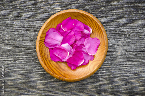 Photo: wild rose brier petal in wooden plate wild rose brier petal in wooden plate