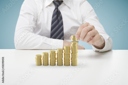 Photo: businessman puts coins businessman puts coins
