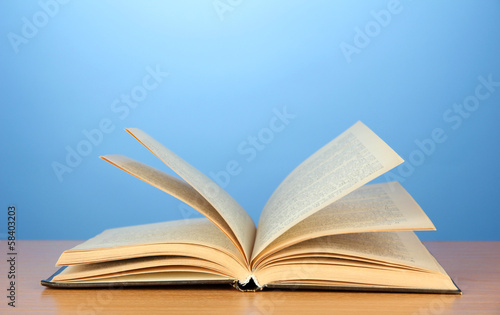 Photo: Opened book on color background Opened book on color background