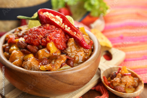 Photo: Chili Corn Carne - traditional mexican food, in wooden bowl, Chili Corn Carne - traditional mexican food, in wooden bowl,