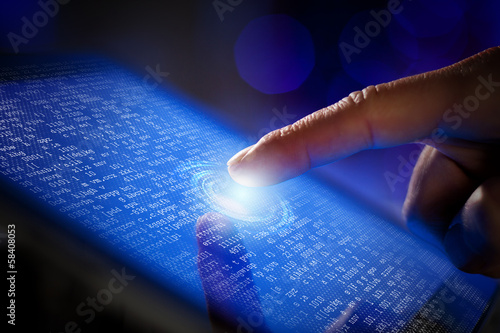 Photo: Closeup of finger touching tablet-pc screen Closeup of finger touching tablet-pc screen