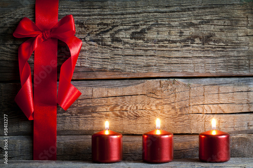 Photo: Christmas abstract background with red ribbon on vintage boards Christmas abstract background with red ribbon on vintage boards