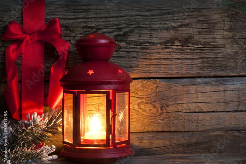 Photo: Christmas abstract background with red ribbon on vintage boards Christmas abstract background with red ribbon on vintage boards