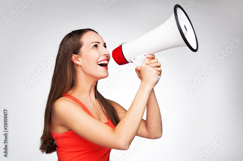 Photo: Woman shouting through megaphone Woman shouting through megaphone