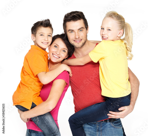 Photo: Happy family with two schoolchild children Happy family with two schoolchild children