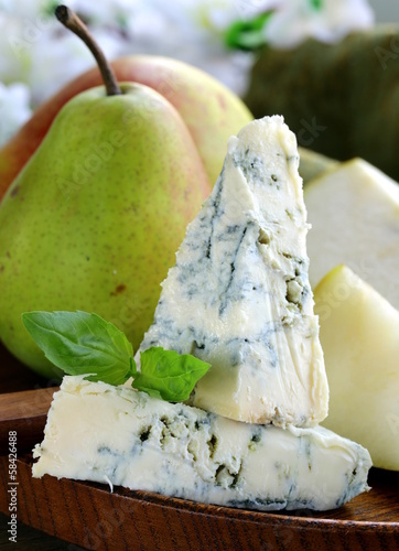 Photo: Blue cheese and pears on a wooden plate Blue cheese and pears on a wooden plate