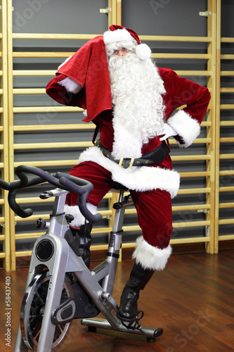 Photo: Santa Claus training on exercise bikes at the gym Santa Claus training on exercise bikes at the gym