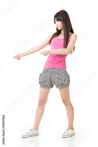 Photo: Young asian woman pulls an imaginary rope Young asian woman pulls an imaginary rope