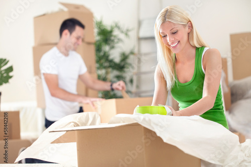 Photo: Couple unpacking boxes Couple unpacking boxes