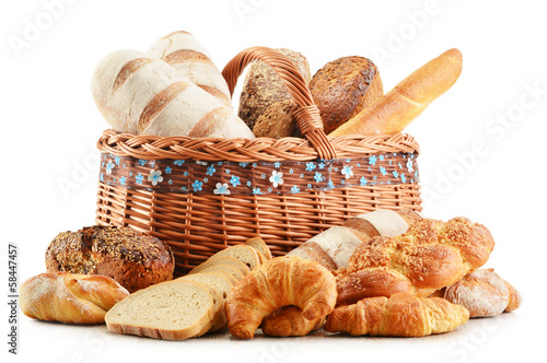 Photo: Wicker basket with baking products isolated on white Wicker basket with baking products isolated on white
