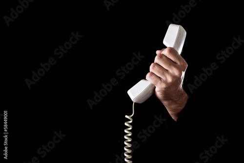 Photo: Hand holding telephone receiver Hand holding telephone receiver