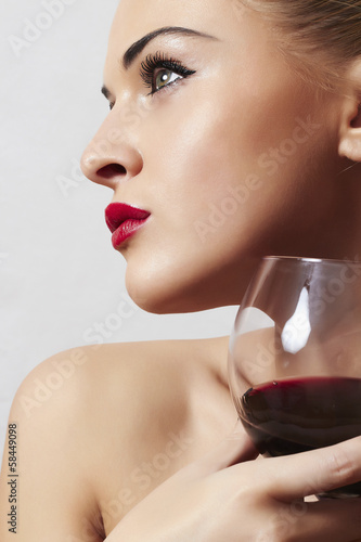 Photo: Beautiful blond woman with wineglass.red lips.dry red wine Beautiful blond woman with wineglass.red lips.dry red wine