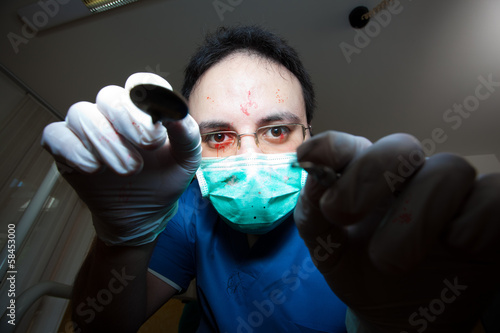 Photo: Crazy sadist dentist torturing a patient Crazy sadist dentist torturing a patient
