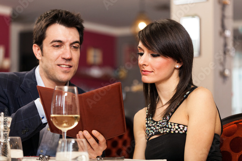 Photo: Couple reading a menu Couple reading a menu