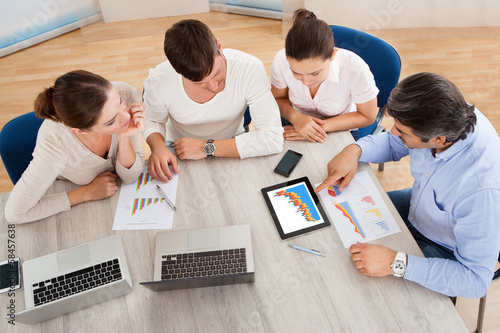 Photo: Business Team In Office Meeting Business Team In Office Meeting