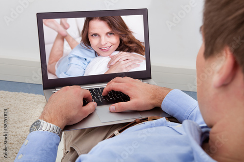 Photo: Man Video Chatting On Laptop Man Video Chatting On Laptop