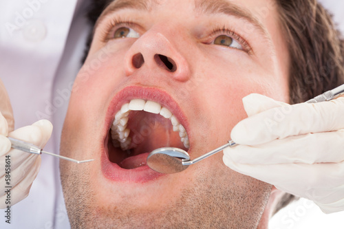 Photo: Dentist Examining Patient Dentist Examining Patient