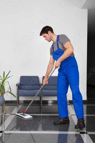 Photo: Man Cleaning The Floor Man Cleaning The Floor
