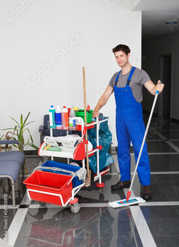 Photo: Young Man With Cleaning Equipment Young Man With Cleaning Equipment
