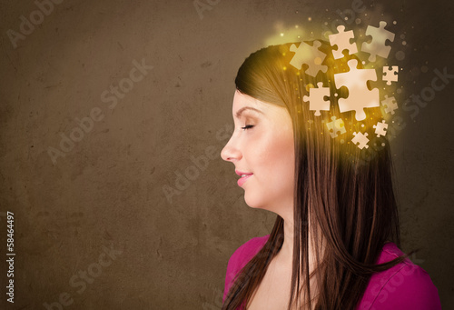 Photo: Young person thinking with glowing puzzle mind Young person thinking with glowing puzzle mind