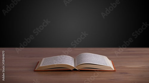 Photo: Open book on wooden deck Open book on wooden deck
