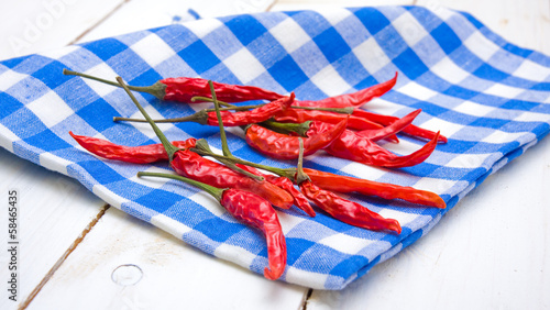Photo: Red hot peppers on plaid napkin Red hot peppers on plaid napkin