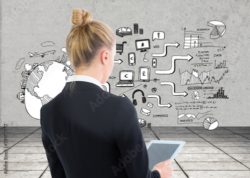Photo: Composite image of businesswoman holding tablet Composite image of businesswoman holding tablet