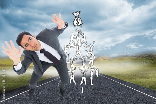 Photo: Composite image of unsmiling businessman with arms raised Composite image of unsmiling businessman with arms raised