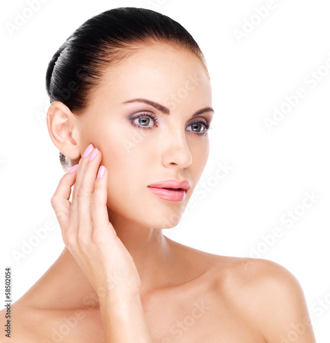 Photo: woman with fresh skin touching cheek by hand woman with fresh skin touching cheek by hand