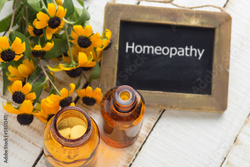 Photo: Herbs and bottle with medicines. Concept homeopathy. Herbs and bottle with medicines. Concept homeopathy.